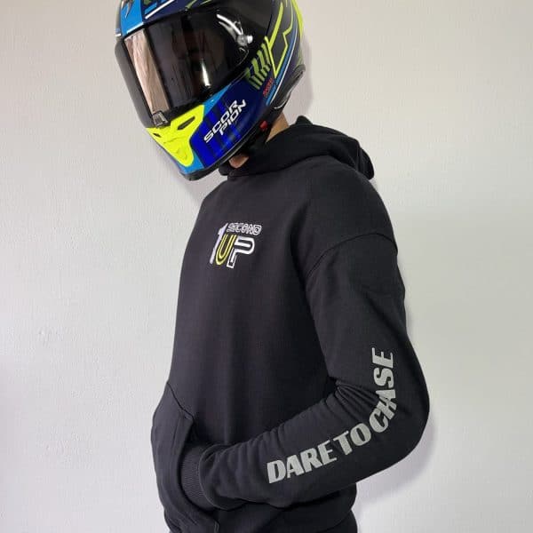 Side profile of a Second 1UP black motorcycle hoodie, featuring 'Dare to Chase' text, styled for motorsports riders