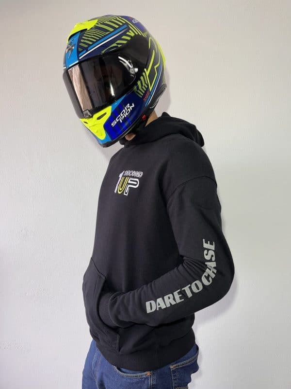 Side profile of a Second 1UP black motorcycle hoodie, featuring 'Dare to Chase' text, styled for motorsports riders