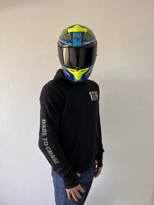 Side profile of a Second 1UP black motorcycle hoodie, featuring 'Dare to Chase' text, styled for motorsports riders