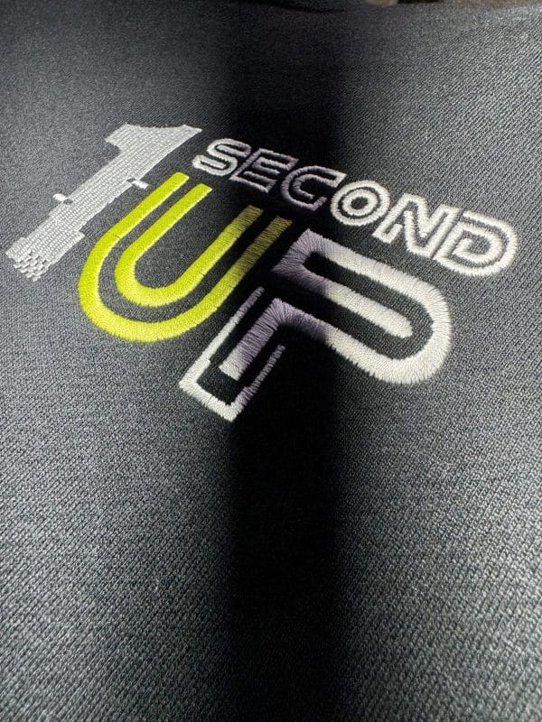 Logo detail of Second 1UP black motorcycle hoodie with a large logo